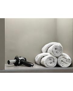 a pile of towels on a shelf in a bathroom at Apartman Jelena in Sremska Mitrovica