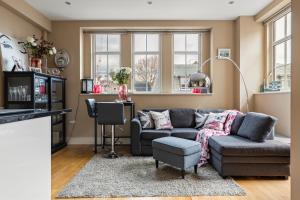 a living room with a couch and a table at Westminster Big Ben Apartment in London