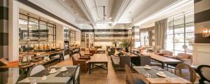 a restaurant with tables and couches and chairs at Hotel Granvia in Barcelona