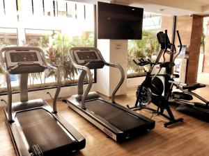 a gym with two exercise bikes and a treadmill at Estudio exclusivo in The City - TOP amenidades! in Playa del Carmen