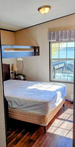 a bedroom with a large bed with a window at Water Front very spacious Cottage on Rice Lake with 5 Star Golf Resort in Keene