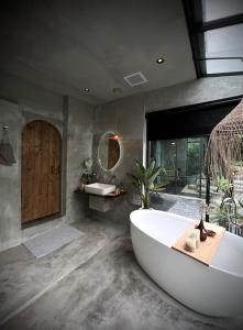 a large bathroom with a tub and a sink at Twilight Forest in Jiufen