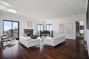 uma sala de estar com dois sofás brancos e um piano em Villa Alana em Los Angeles