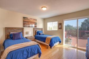 a bedroom with two beds and a balcony at Vallejo Home with Spacious Deck, Hot Tub and Views in Vallejo