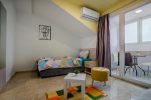 a small bedroom with a bed and a table at Makedon Apartments with FREE PARKING in Ohrid