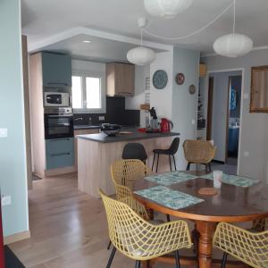 a kitchen and dining room with a table and chairs at PILOUBELLE 