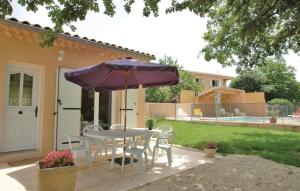 a table and chairs with an umbrella on a patio at 3 Bedroom Nice Home In Saint-Thomé in Saint-Thomé +10 photos