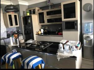 a kitchen with a black and white stove top oven at Chalet in Zāwiyat Ashţūr