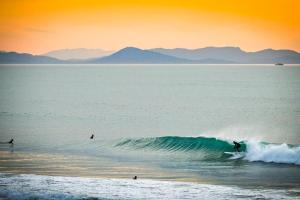 a person riding a wave on a surfboard in the ocean at Maisonnette à Vieux-Boucau in Soustons +2 photos