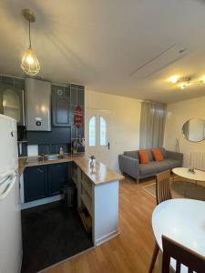 a kitchen and living room with a couch and a table at Le floquet in Vitry-sur-Seine