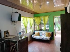 a living room with a couch and some windows at La casita JSL 