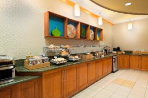 a large kitchen with a buffet of food on the counter at SpringHill Suites Fort Myers Airport in Fort Myers