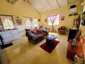 a living room with a couch and a table at Comfort Suites - One Bedroom Apartment in Choiseul