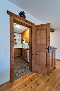a kitchen with a door open to a kitchen with a counter at Chesa Pradash - Celerina in Celerina