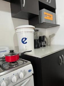 a kitchen with a stove with a pot on it at Apartamento Tesoro-Ciudad de Guatemala zona 2 de Mixco in Guatemala