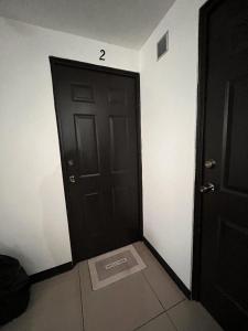 a black door with the number on it in a room at Apartamento Tesoro-Ciudad de Guatemala zona 2 de Mixco in Guatemala