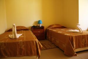 A bed or beds in a room at Hotel Lazareto