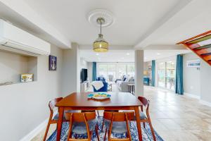 a dining room and living room with a table and chairs at Valentine Creek Retreat in Odenton