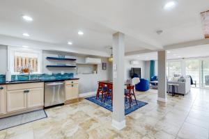 a kitchen and living room with blue counter tops at Valentine Creek Retreat in Odenton