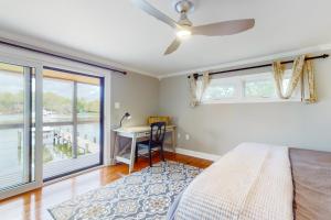 a bedroom with a bed and a table and a window at Valentine Creek Retreat in Odenton