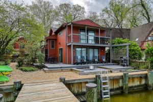 a house on the water with a dock at Valentine Creek Retreat in Odenton