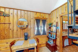 a dining room with a table and a mirror at Idyllwild Retreat in Idyllwild