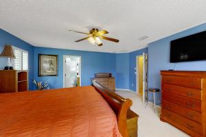 a bedroom with a bed and a ceiling fan at The Home on Tyson Lake Drive in Jacksonville