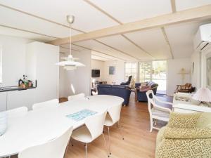 a dining room and living room with a white table and chairs at 6 person holiday home in Kalundborg-By Traum in Kalundborg