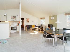 a living room with a table and a dining room at 6 person holiday home in Vig in Vig