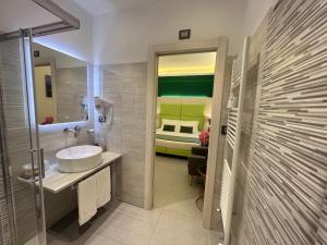 a bathroom with a sink and a bed in a room at Cinque Terre Behind in La Spezia +83 photos