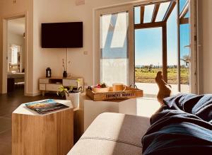 a person laying on a bed looking out of a window at Agriturismo Il Querciolo in Grosseto