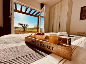 a wooden tray with a bowl of fruit on a bed at Agriturismo Il Querciolo in Grosseto +61 photos