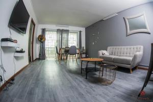 a living room with a couch and a table at Appartement moderne à la Marina du Gosier in Le Gosier
