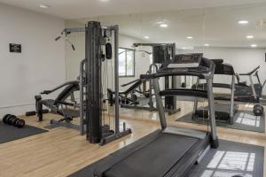 a gym with several tread machines in a room at Hotel Malibu in Guadalajara