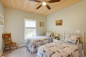 Un dormitorio con dos camas y un ventilador de techo. en Oceanfront Prospect Harbor House with Deck, View, en Prospect Harbor