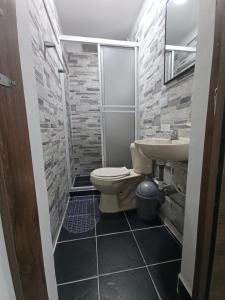 a bathroom with a toilet and a sink at apartaestudio con 2 camas cerca al centro y parqueadero GRATIS in Popayan