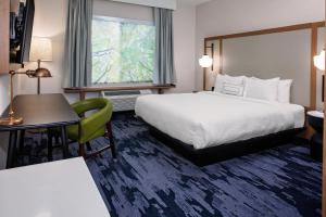 a hotel room with a bed and a desk and a window at Fairfield by Marriott Port Clinton Waterfront in Port Clinton