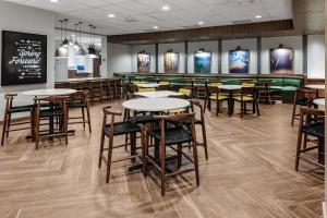 a restaurant with tables and chairs and a bar at Fairfield by Marriott Port Clinton Waterfront in Port Clinton