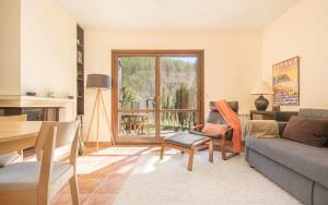 a living room with a couch and a table at Chalet El Molino de Castiello in Castiello de Jaca