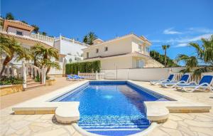 a swimming pool in front of a house at Awesome Home In Riviera Del Sol With 3 Bedrooms, Wifi And Outdoor Swimming Pool in La Cala de Mijas