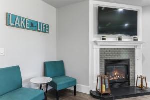 a living room with two chairs and a fireplace at Williams Bay House - Cherry Street Retreat in Lake Geneva