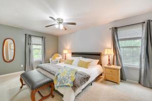 a bedroom with a bed and a ceiling fan at Peaceful Rogers Home Near Beaver Lake! in Rogers