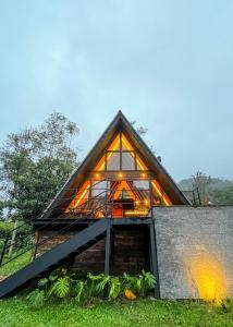 a house with a large window on the side of it at Cabana da Mata - Teresópolis in Teresópolis