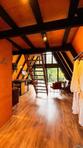 an attic room with a wooden floor and wooden ceilings at Cabana da Mata in Teresópolis
