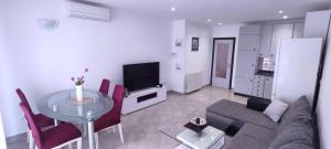 a living room with a couch and a table at Apartments by the sea nska, Krk - 21205 in Malinska