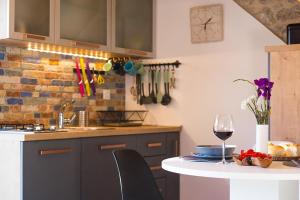 a kitchen with a table with a glass of wine at Secluded house with WiFi Zlarin - 21177 in Zlarin