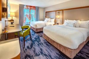 a hotel room with two beds and a desk at Fairfield by Marriott at Lakewood Ranch - Sarasota in Sarasota