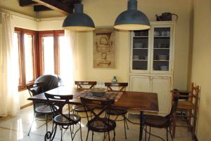 a dining room with a wooden table and chairs at Torre Viladot in Solsona