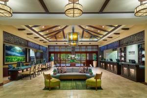 a lobby of a resort with a couch and chairs at The Westin Princeville Ocean Resort Villas in Princeville