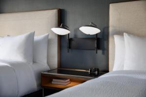 a hotel room with two beds and a table with two lamps at Courtyard by Marriott Chicago Downtown/River North in Chicago